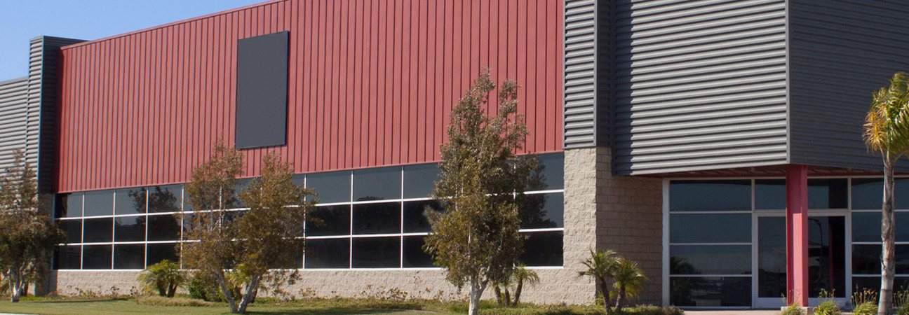 A red and grey metal-clad commercial building